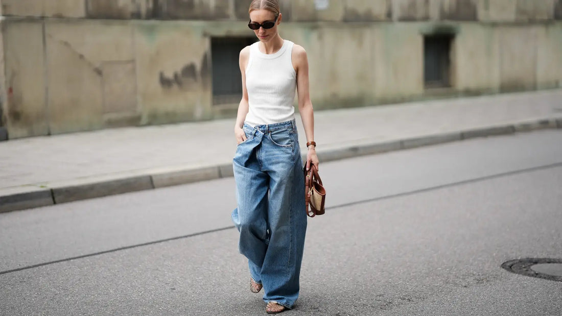 Person in baggy streetwear jeans, city street.